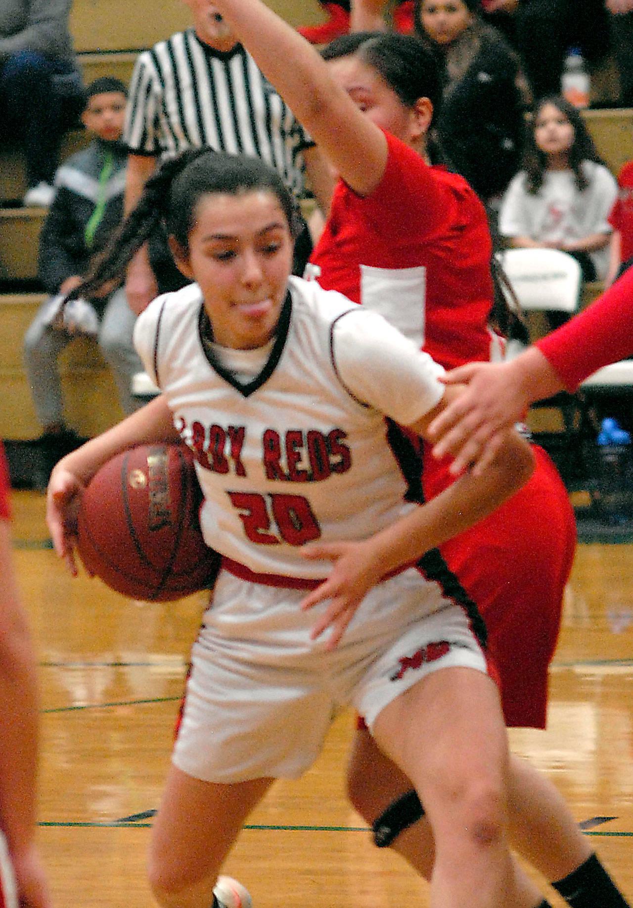 Neah Bays CeiJ Gagnon fights off defenders during her team’s February game against Tulalip Heritage. (Keith Thorpe/Peninsula Daily News file)