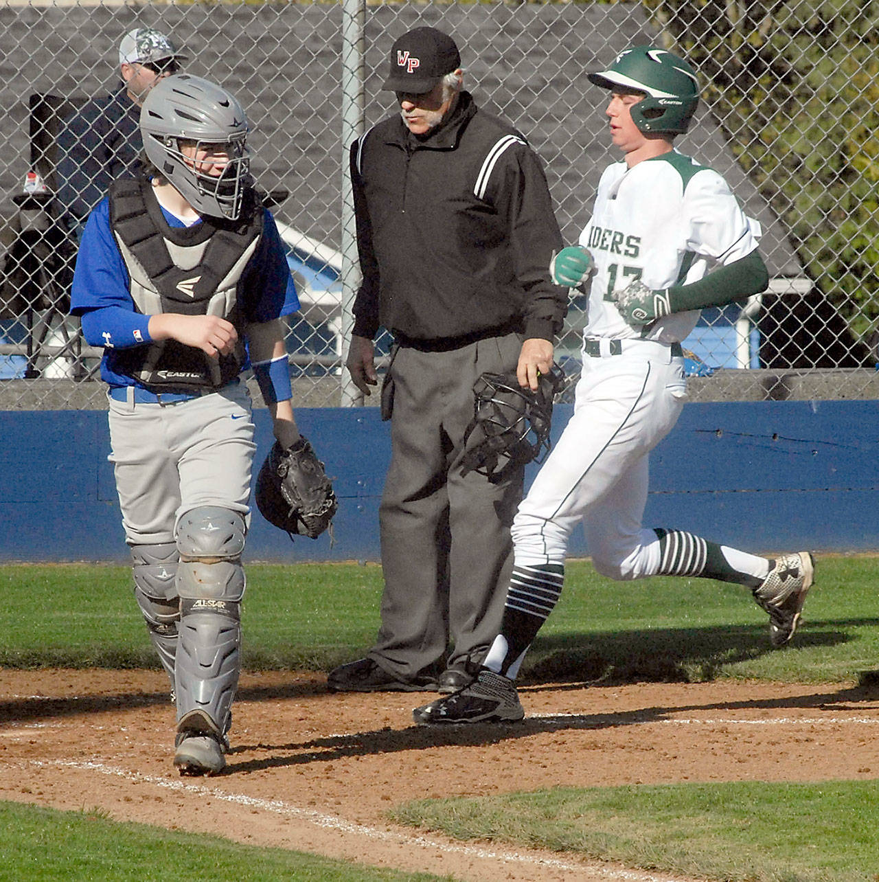 Port Angeles’ Ethan Flodstrom, right, crosses home plate in an April 2018 game against Bremerton. Flodstrom has committed to play baseball at Tacoma Community College. (Keith Thorpe/Peninsula Daily News file)