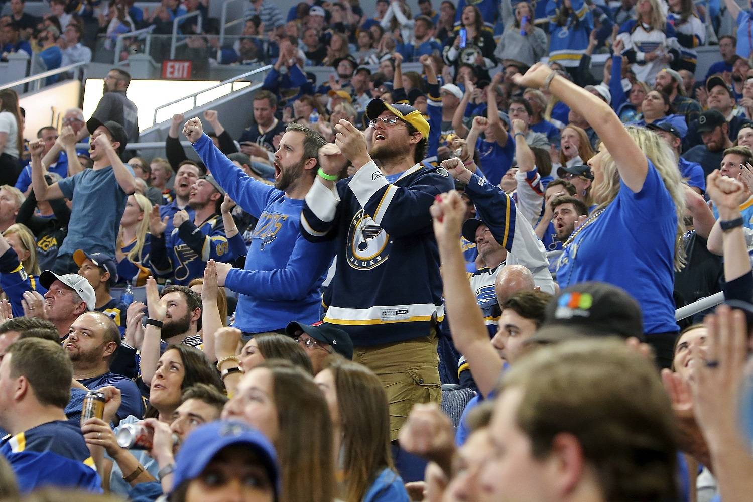 The Associated Press St. Louis Blues fans cheer as they watch television coverage of Game 7 of the team’s NHL hockey Stanley Cup Final against the Boston Bruins, from seats at Enterprise Center in St. Louis in June 2019.                                In this June 12, 2019, file photo, St. Louis Blues fans cheer as they watch television coverage of Game 7 of the team’s NHL hockey Stanley Cup Final against the Boston Bruins, from seats at Enterprise Center nin St. Louis. With the distinct possibility of pro sports resuming in empty venues, a recent poll suggests a majority of U.S. fans wouldn’t feel safe attending games anyway without a coronavirus vaccine. (Scott Kane/The Associated Press file)