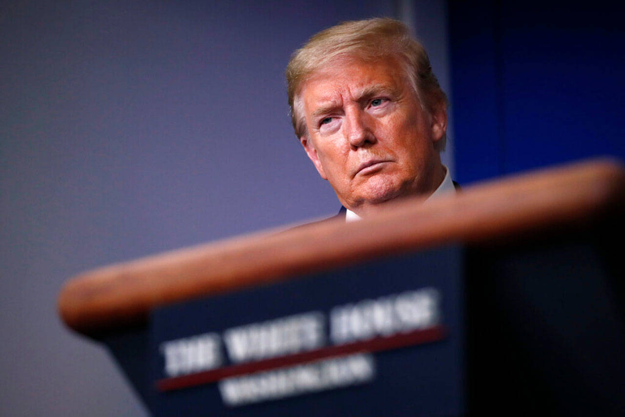 In this April 22, 2020, file photo, President Donald Trump listens during a briefing about the coronavirus in the James Brady Press Briefing Room of the White House, in Washington. After two months of frantic response to the coronavirus pandemic, the White House is planning to shift President Trump’s public focus to the burgeoning efforts aimed at easing the economic devastation. (Alex Brandon/Associated Press file)