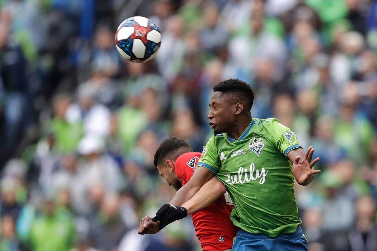 In this Nov. 10, 2019, file photo, Seattle Sounders’ Kelvin Leerdam, right, heads the ball in front of Toronto FC’s Jonathan Osorio during the second half of the MLS Cup championship soccer match in Seattle. Leerdam has been fortunate compared to many of the other foreign players in Major League Soccer, and it was completely by accident. Born in Suriname but raised in the Netherlands, Leerdam still makes his full-time home in Europe when he’s not playing for the Seattle Sounders. When the school schedule in the Netherlands lined up for his wife and two young children to join him in Seattle for the start of the MLS season in early March, Leerdam jumped at the chance to have his family together. Little did they know that the COVID-19 virus pandemic was about to overtake much of the world, making travel for his family a major challenge. (Elaine Thompson/Associated Press file)