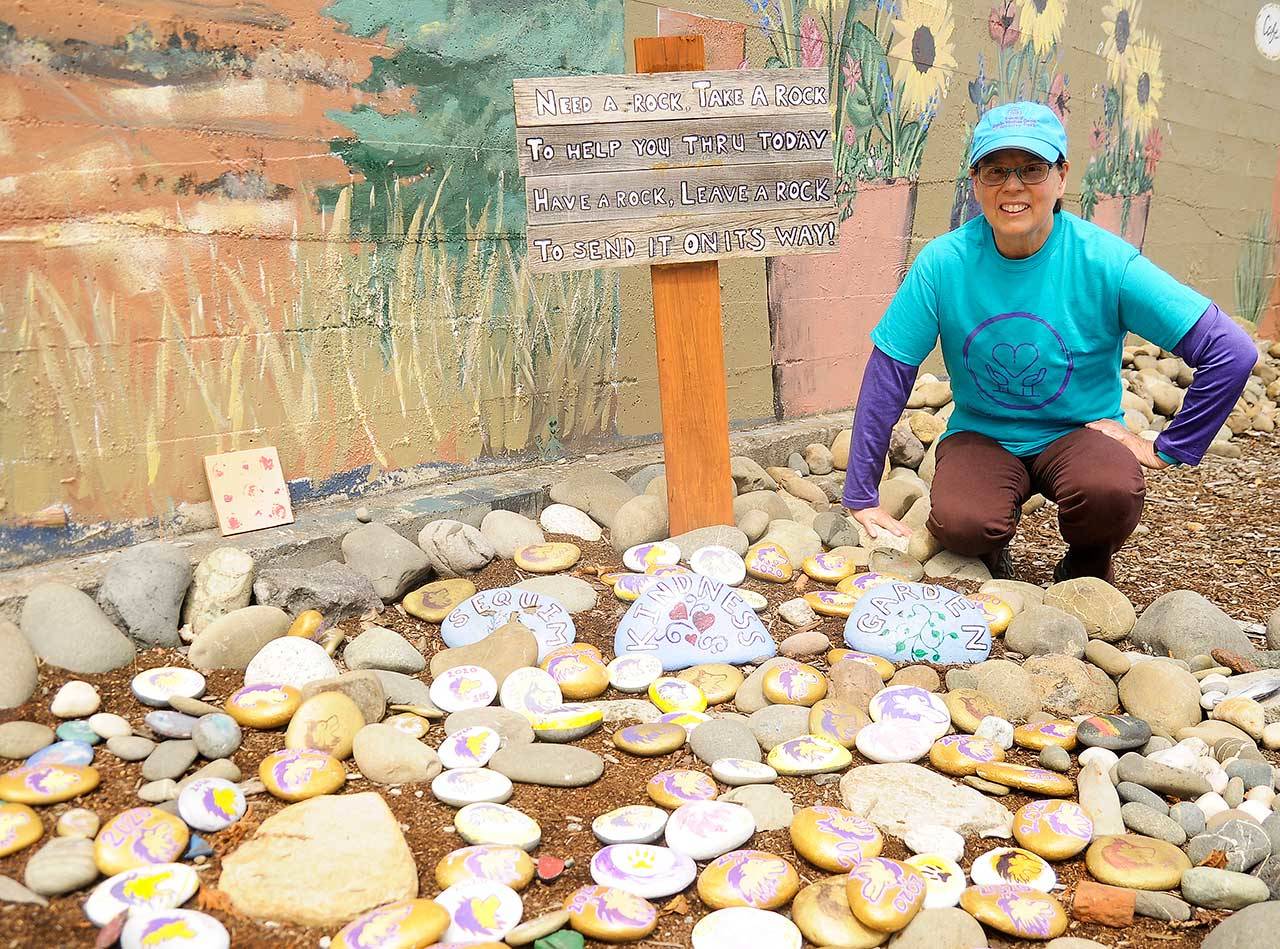 Sarah Miller shows some of the rocks created for Sequim High School’s Class of 2020 at Whimsy Park in downtown Sequim.