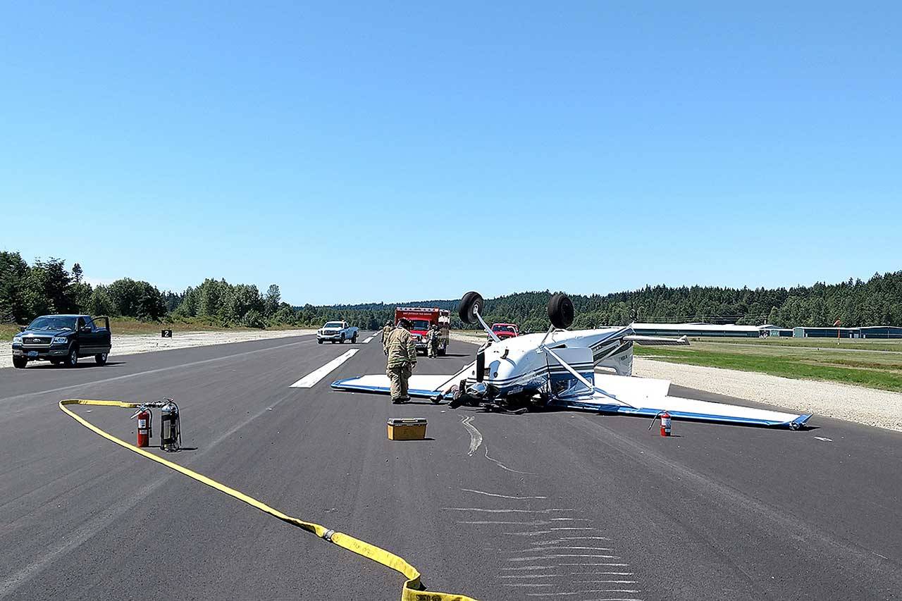 Firefighters from East Jefferson Fire Rescue tend to a plane that overturned on the runway at Jefferson County International Airport on Monday. (East Jefferson Fire Rescue)