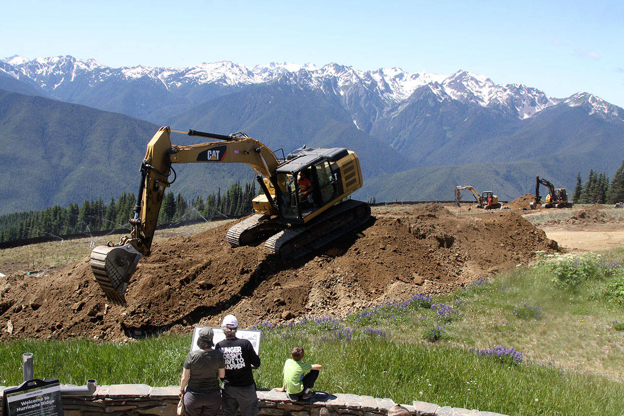 Visitors to the Hurricane Ridge Visitor Center watch as workers with Northwest Cascades remove sod and start digging trenches for the new system. (Dave Logan/for Peninsula Daily News)