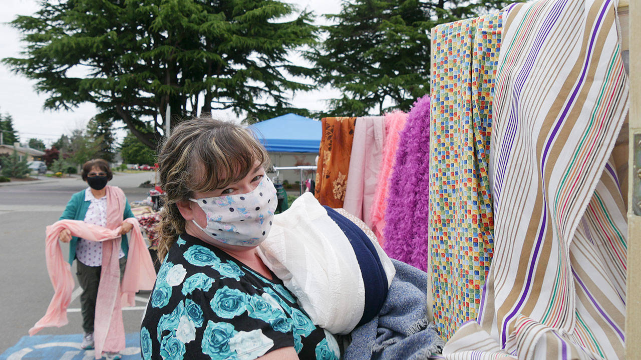 Sara Jane Benjamin, right, and Elena Karr set up items for display at Olympic Theatre Arts Center’s rummage sale on July 11. Photo courtesy of Olympic Theatre Arts Center