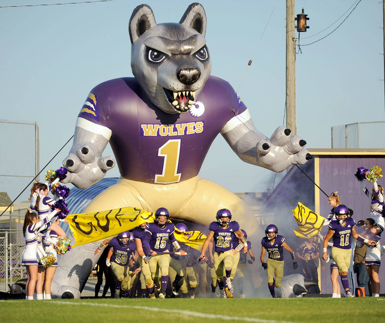 Sequim football players run out of the tunnel before their 2019 season opener against Washington last September. High school football has been moved to March under a four-season high school athletics plan released by the WIAA. (Michael Dashiell/Olympic Peninsula News Group)