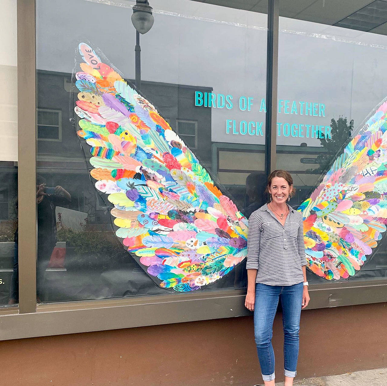 Juan de Fuca Foundation Executive Director Kayla Oakes helped assemble some 250 feathers, painted by local youngsters, into the wings on display at First and Laurel streets in downtown Port Angeles. (Juan de Fuca Foundation for the Arts)