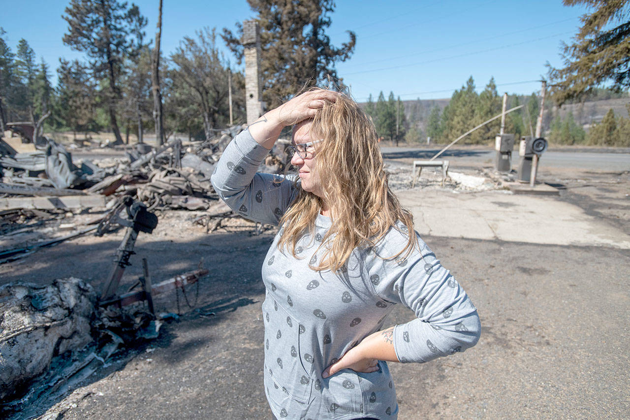 Hollie Jordan surveys her father’s service station that was destroyed by a wildfire on Tuesday in Malden, Wash. “This was filled with work and life and memories, and it’s all gone,” said Jordan. (Jed Conklin/Associated Press)