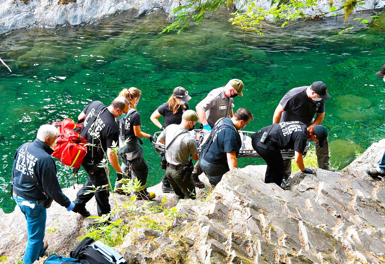 An unidentified woman is carried up to the Salmon Cascades parking lot after she fell Sunday, Sept. 13, 2020. (Clallam County District 2)