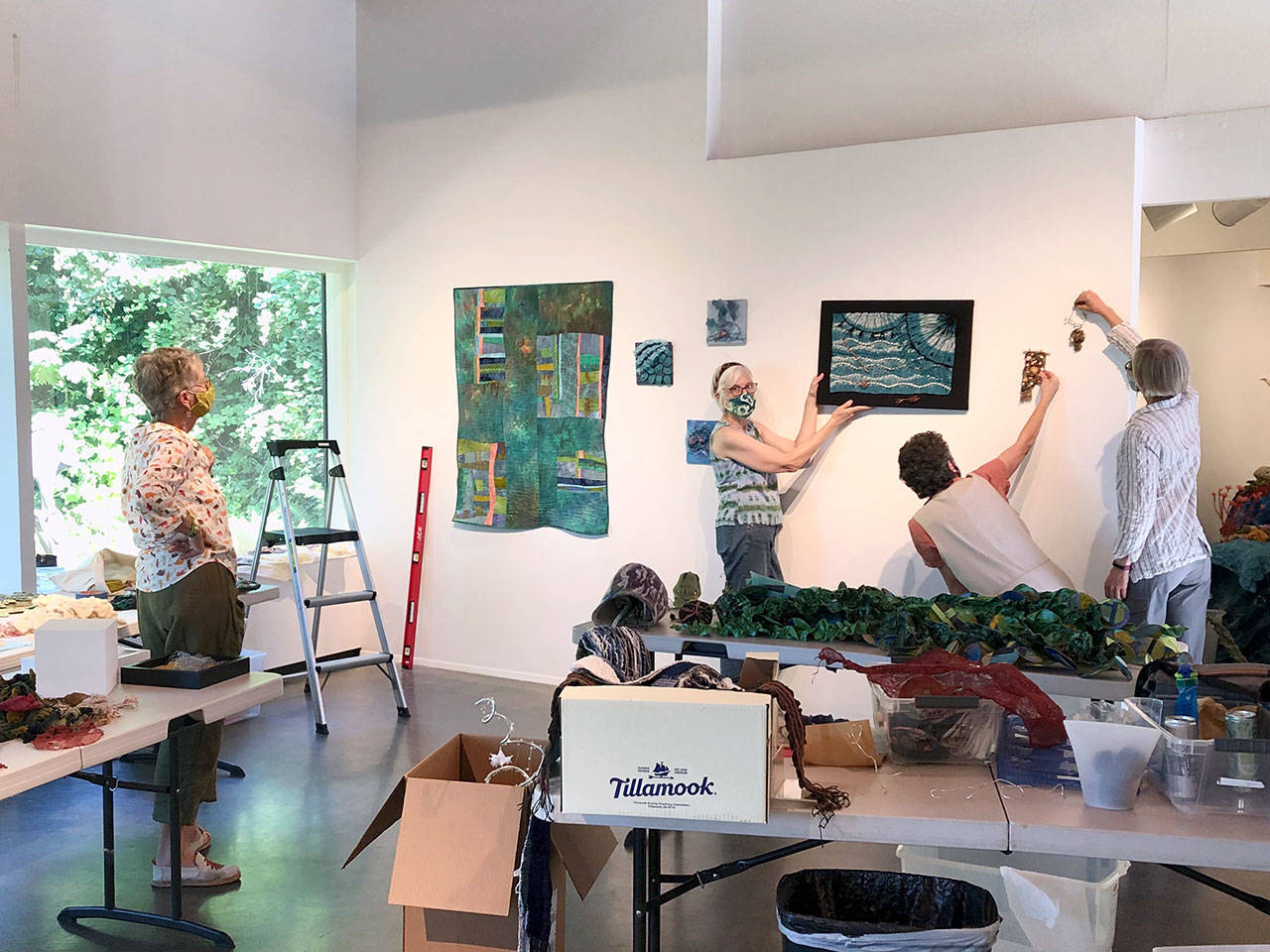 The four artists of Tangled Fibers are pictured as they installed their Undersea Garden exhibit. From left are Pat Herkal, Barbara Ramsey, Jean-Marie Tarascio and Cathie Wier. (Courtesy photo)