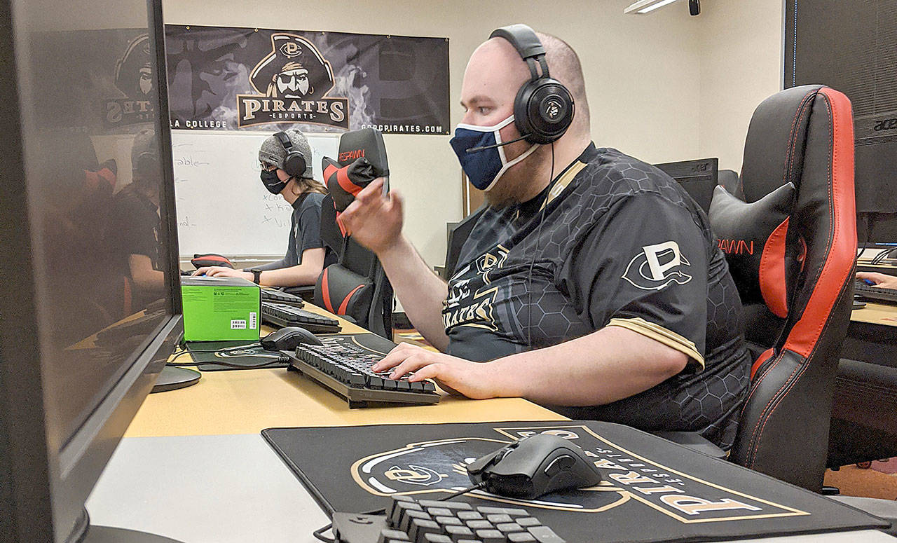 Cameron Fouts, left, and Mike Roggenbuck, right, of the Peninsula College esports team competes last week against Dawson Community College of Montana. (Peninsula College)