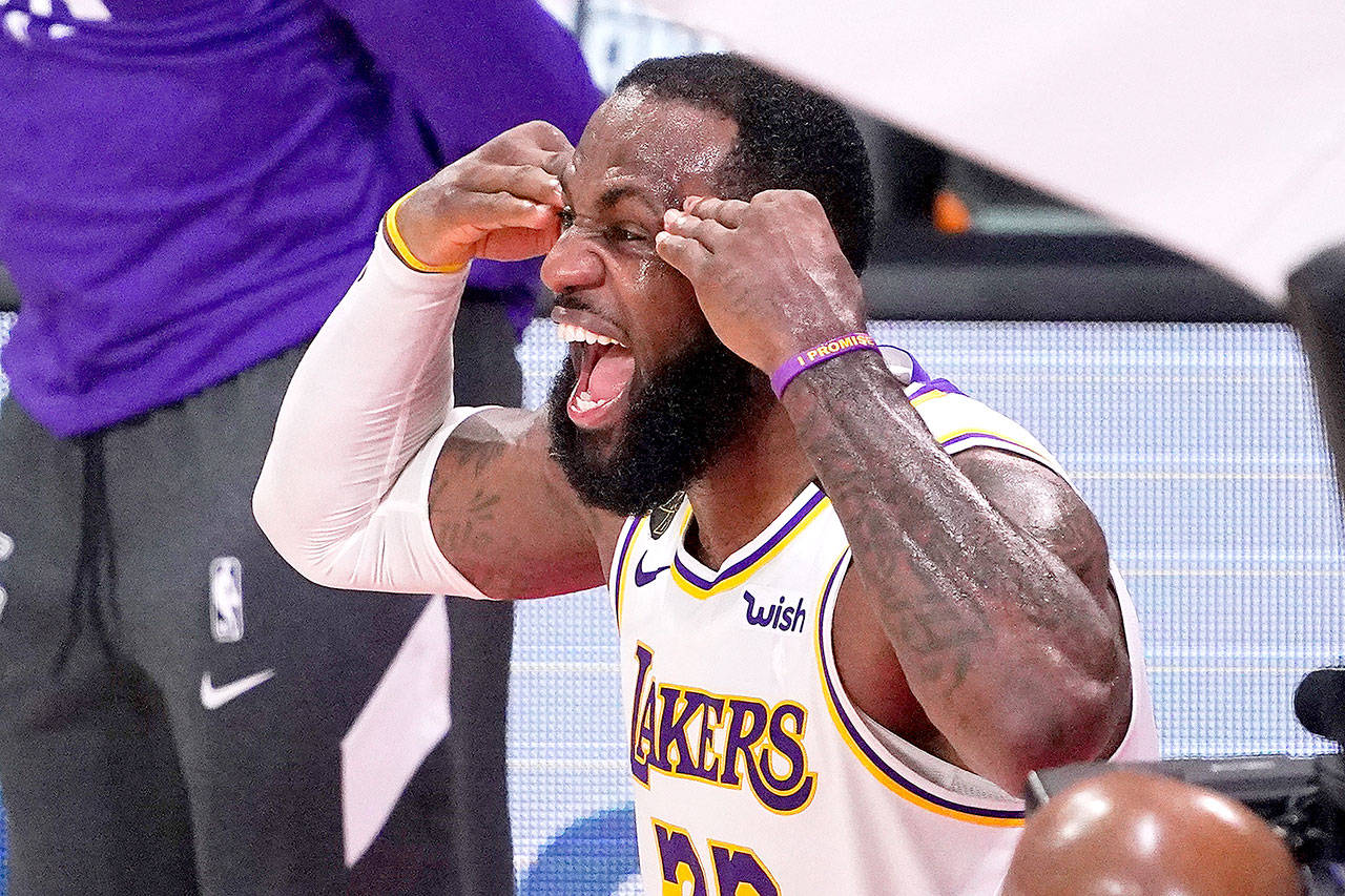 Los Angeles Lakers’ LeBron James (23) celebrates after the Lakers defeated the Miami Heat 106-93 in Game 6 of basketball’s NBA Finals on Sunday, Oct. 11, 2020, in Lake Buena Vista, Fla. (Mark J. Terrill/Associated Press)