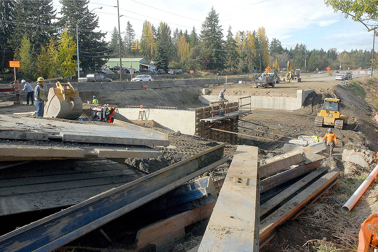 Crews work to replace the north portion of a set of culverts under U.S. Highway 101 at Bagley Creek east of Port Angeles. (Keith Thorpe/Peninsula Daily News)