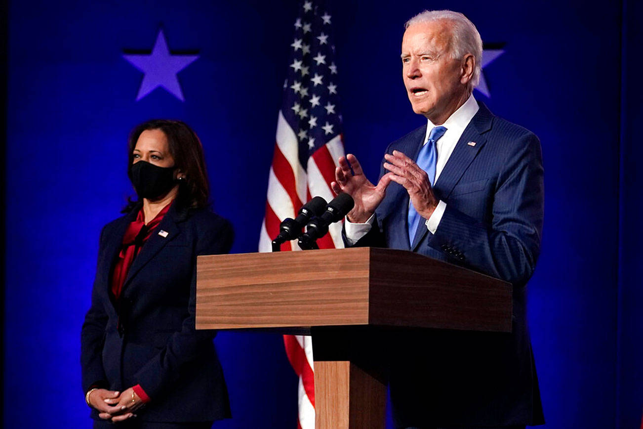 Democratic vice presidential candidate Sen. Kamala Harris, D-Calif., listens as Democratic presidential candidate former Vice President Joe Biden speaks Friday, Nov. 6, 2020, in Wilmington, Del. (AP Photo/Carolyn Kaster)