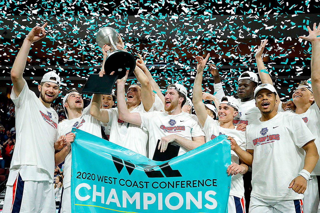 FILE - Gonzaga players celebrate after defeating Saint Mary's in an NCAA college basketball game in the final of the West Coast Conference men's tournament in Las Vegas, in this Tuesday, March 10, 2020, file photo.  Gonzaga will begin the college basketball season No. 1 for the first time after coach Mark Few's bunch earned 28 first-place votes in the preseason AP Top 25 poll released Monday, Nov. 9, 2020.(AP Photo/John Locher, File)