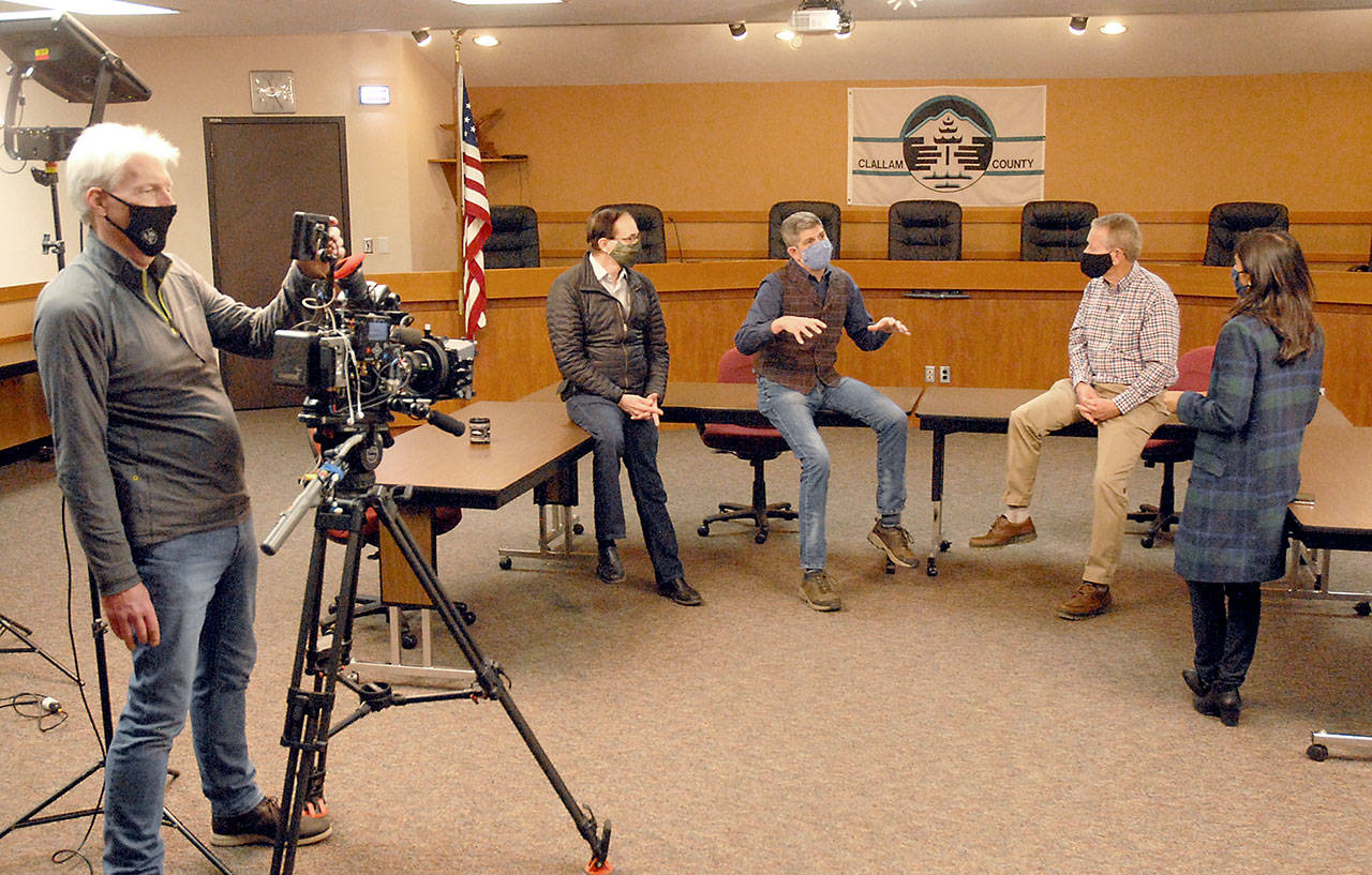 Clallam County commissioners, from center left, Bill Peach, Mark Ozias and Randy Johnson take part in an interview with ABC correspondent Zohreen Shah as cameraman Glenn Aust films the proceeding on Friday at the Clallam County Courthouse in Port Angeles. (Keith Thorpe/Peninsula Daily News)