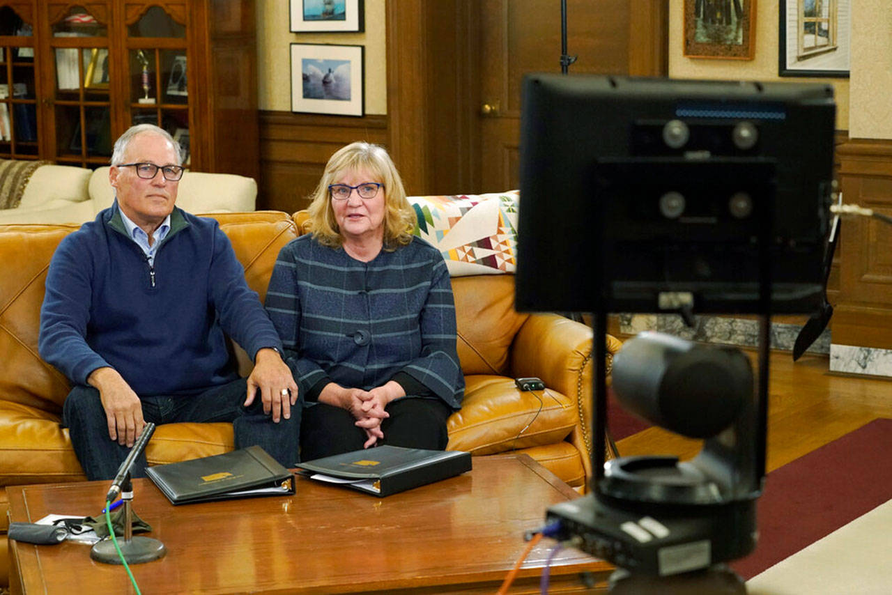 Washington Gov. Jay Inslee and his wife, Trudi, rehearse in the governor’s office as they prepare to make a statewide televised address on COVID-19, which health officials have warned is accelerating rapidly throughout the state Thursday, Nov. 12, 2020, at the Capitol in Olympia. (Ted S. Warren/Associated Press)