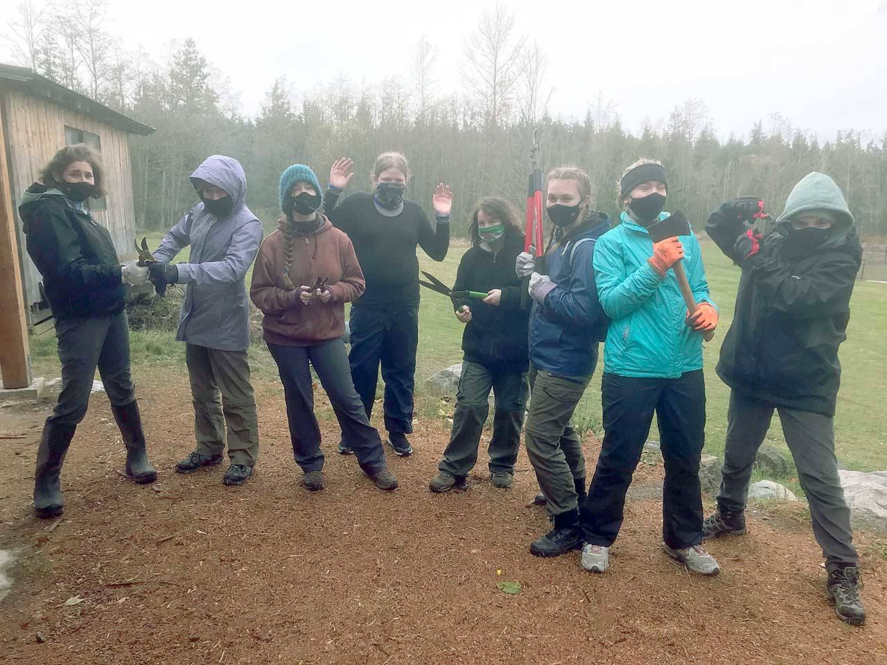 Sequim Scout Troop 1498 gears up to attack and trim back overgrown native roses, blackberries and brush along the trails at Layton Hill Horse Camp. They also camped and learned trail safety rules from the Peninsula chapter of Back Country Horsemen. (Carrie Kalina)