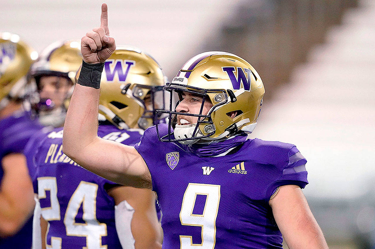 Washington quarterback Dylan Morris gestures after Washington defeated Utah 24-21 Nov. 28 in Seattle. (AP Photo/Ted S. Warren)