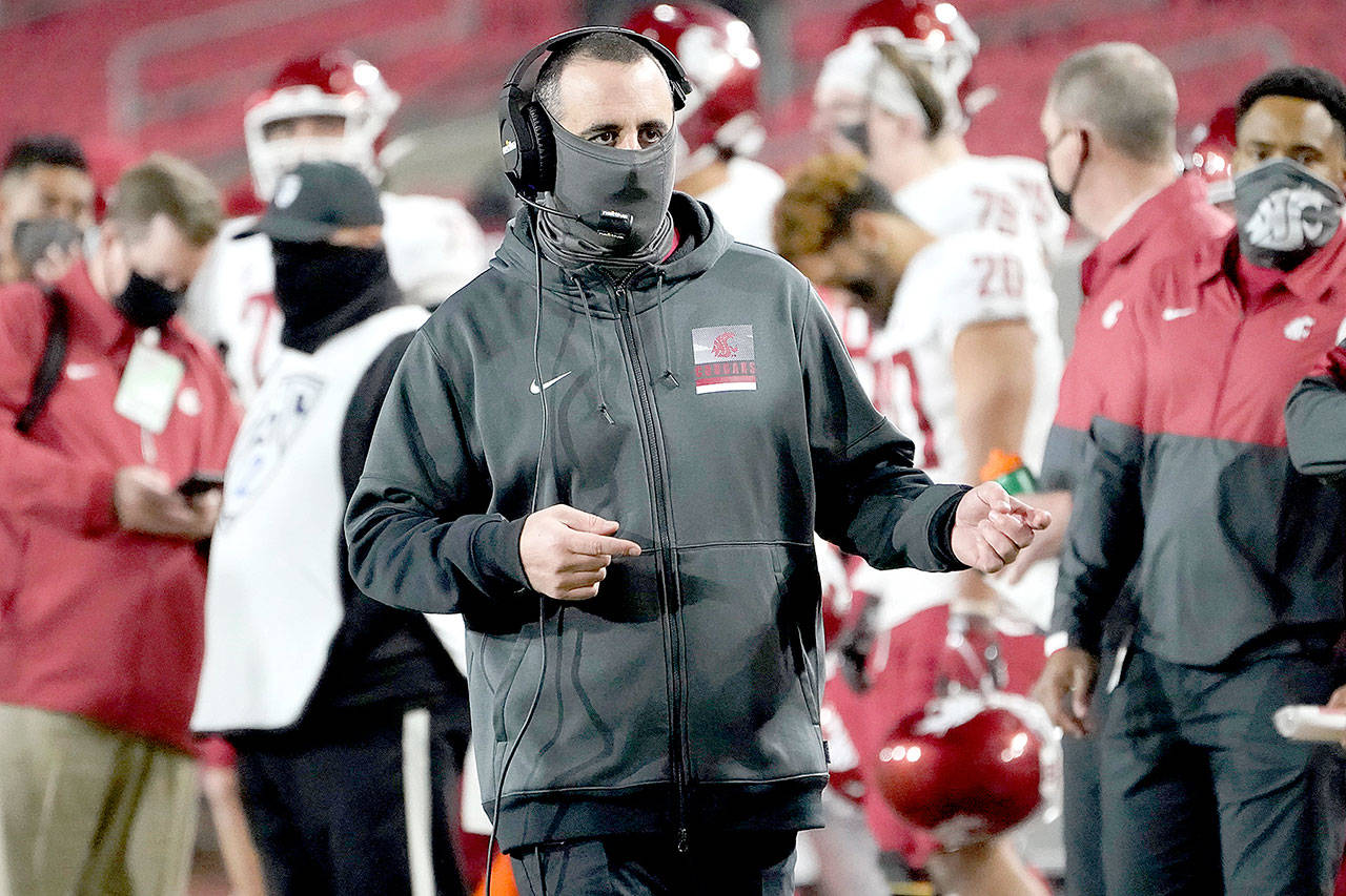 Washington State head coach Nick Rolovich walks the sideline against Southern California in Los Angeles on Dec. 6. (Alex Gallardo/Associated Press)