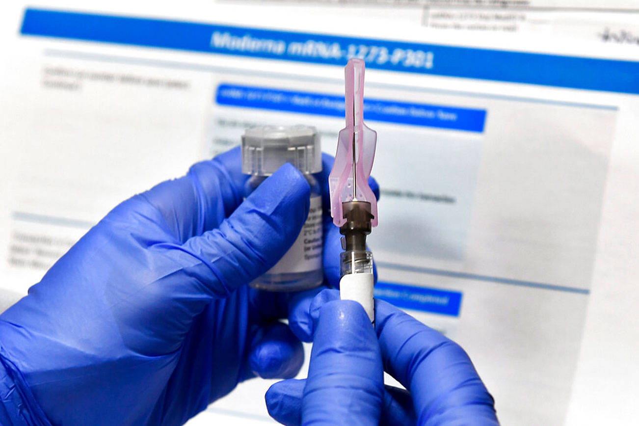 FILE - In this July 27, 2020, file photo, a nurse prepares a shot as a study of a possible COVID-19 vaccine, developed by the National Institutes of Health and Moderna Inc., gets underway in Binghamton, N.Y. The U.S. is poised to give the green light as early as Friday, Dec. 18, to a second COVID-19 vaccine, a critical new weapon against the surging coronavirus. Doses of the vaccine developed by Moderna Inc. and the National Institutes of Health will give a much-needed boost to supplies as the biggest vaccination effort in the nation’s history continues. (AP Photo/Hans Pennink, File)