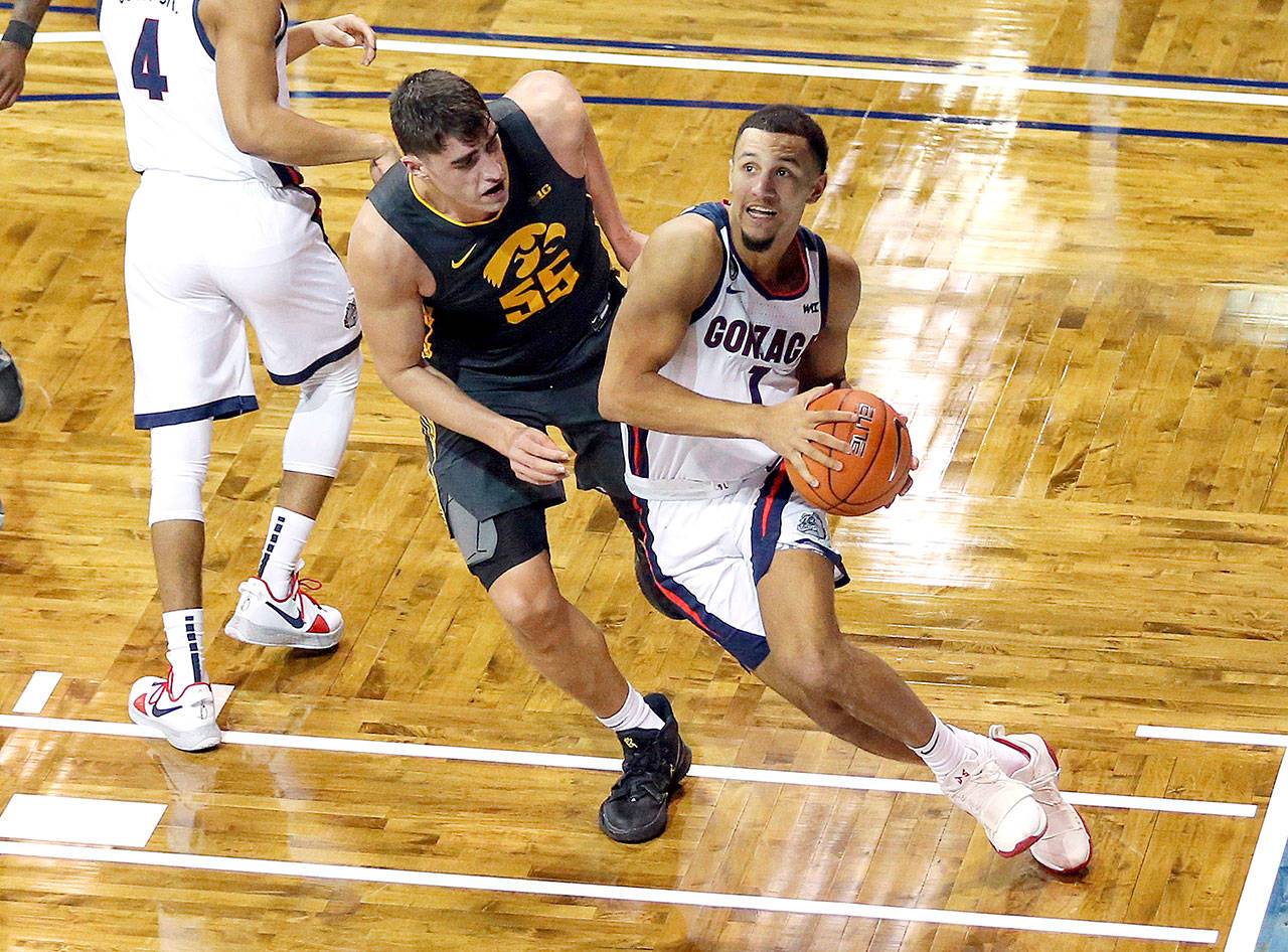 Gonzaga guard Jalen Suggs (1) drives the baseline against Iowa defender Luka Garza (55) during the second half of an NCAA college basketball game Saturday, Dec. 19, 2020 in SIoux Falls, S.D. (AP Photo/Josh Jurgens)