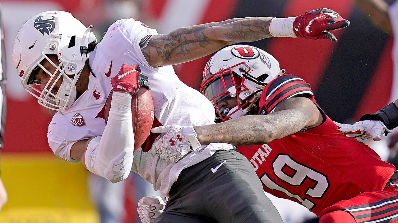 Washington State running back Deon McIntosh (3) scores against Utah safety Vonte Davis (19) during the first half of an NCAA college football game Saturday, Dec. 19, 2020, in Salt Lake City. (AP Photo/Rick Bowmer)