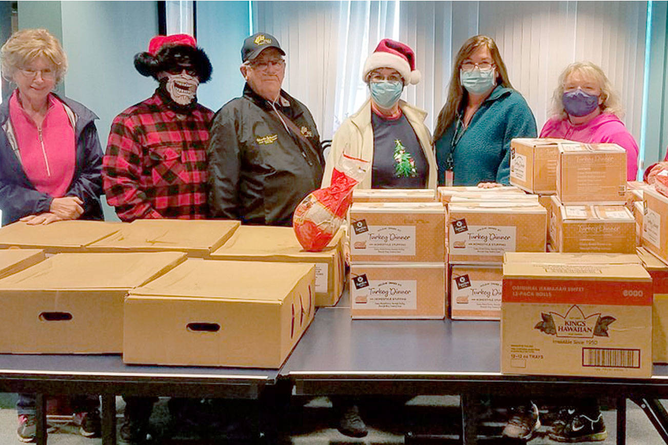 Helga Greer, left, Randy Yard, Charlie Johnson, Maura Mattson, Jennifer Petty, Valerie Brooks and Cat Yard, members of Sequim Elks Lodge No. 2642 and staff of the Clallam County Juvenile and Family Services' child advocate program, pause in delivering Christmas meals to foster families. The lodge used a $3,500 Beacon Grant from the Elks National Foundation to purchase 50 complete dinners for the foster families in the program.