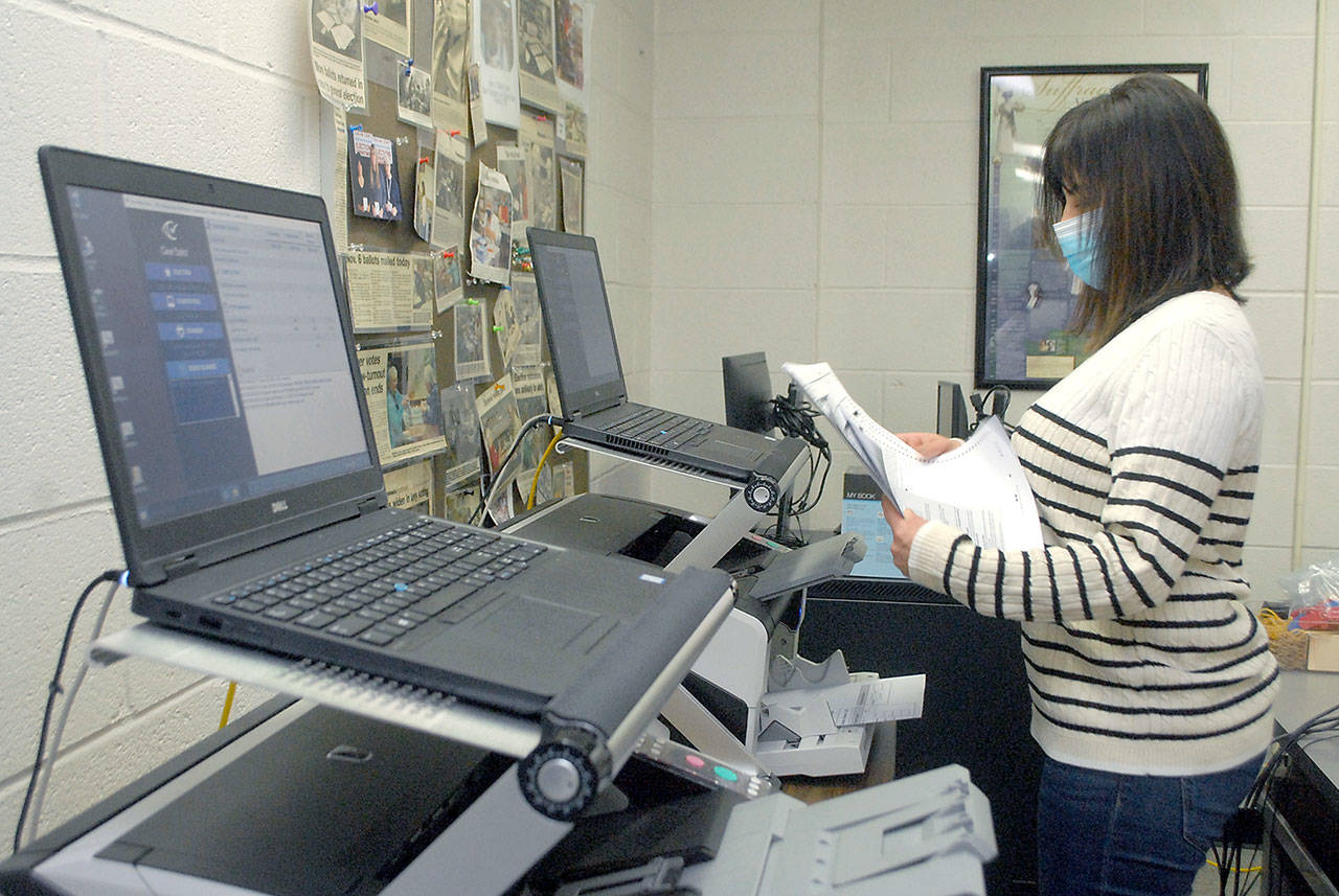 Keith Thorpe/Peninsula Daily News
Clallam County Elections Supervisor Susan Johnson leafs through a stack of test ballots during a logic and accuracy test of the county's two ballot scanners on Wednesday at the Clallam County Courthouse in Port Angeles. The test, performed before every election, showed that the scanners came up with the expected results and passed certification.