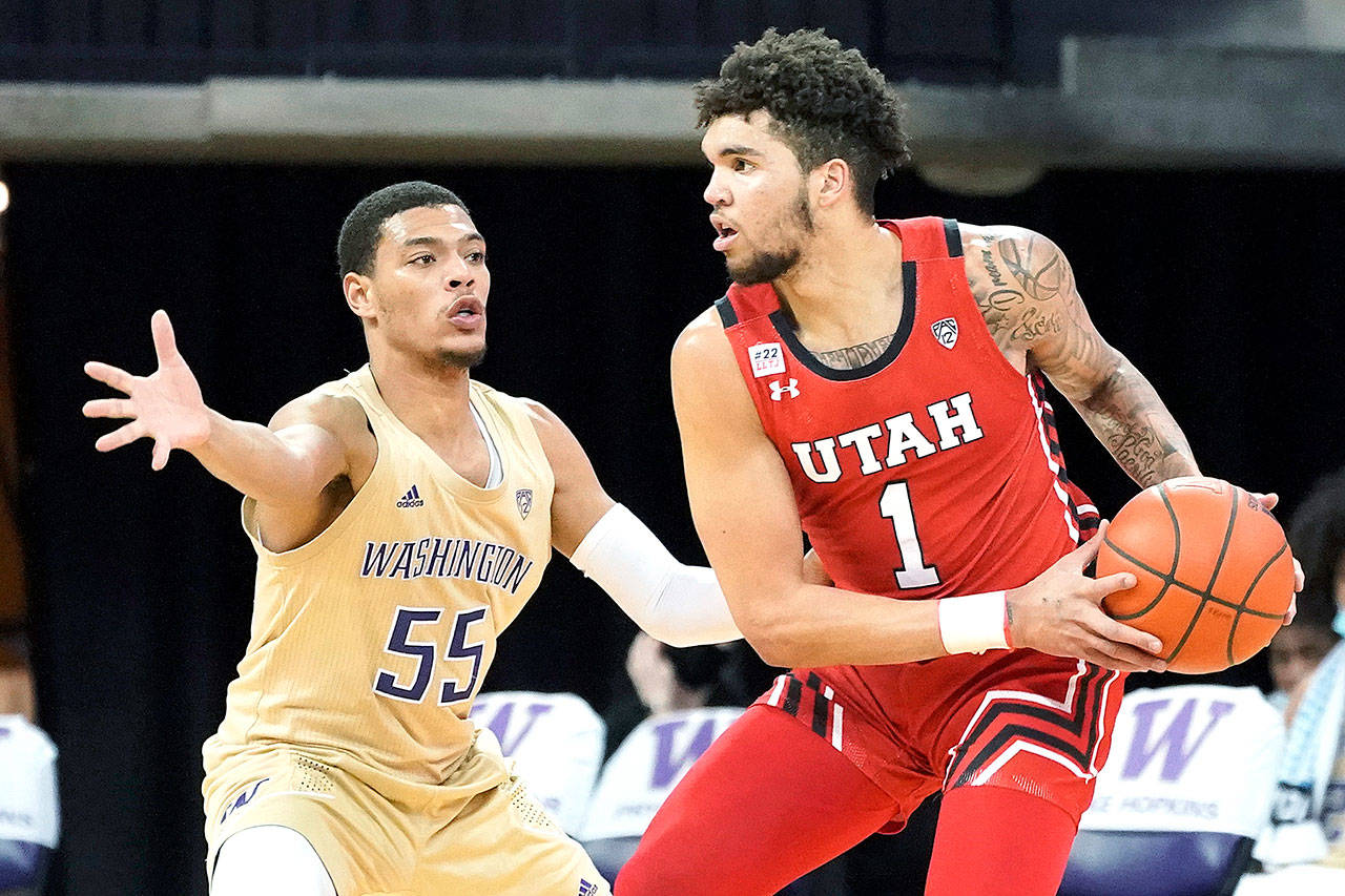 Utah forward Timmy Allen (1) tries to get around Washington guard Quade Green (55) during the first half of an NCAA college basketball game, Sunday, Jan. 24, 2021, in Seattle. (AP Photo/Ted S. Warren)