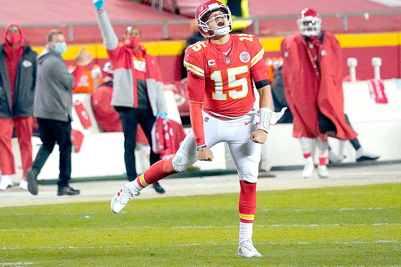 Kansas City Chiefs quarterback Patrick Mahomes celebrates after throwing a 5-yard touchdown pass to tight end Travis Kelce during the second half of the AFC championship NFL football game against the Buffalo Bills, Sunday, Jan. 24, 2021, in Kansas City, Mo. (AP Photo/Jeff Roberson)