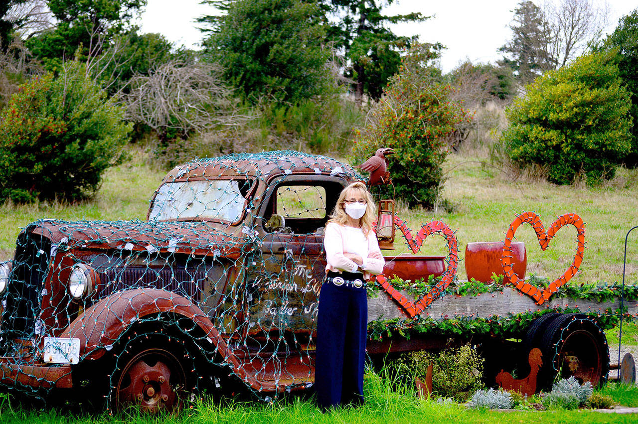 Barber Debbie Hinton of Port Townsend’s Victorian Clipper barbershop had a vintage truck towed in from Chimacum decades ago, with the intention of planting a garden in it. These days it’s a changing holiday display festooned in February with Valentine’s Day decor. (Diane Urbani de la Paz/Peninsula Daily News)