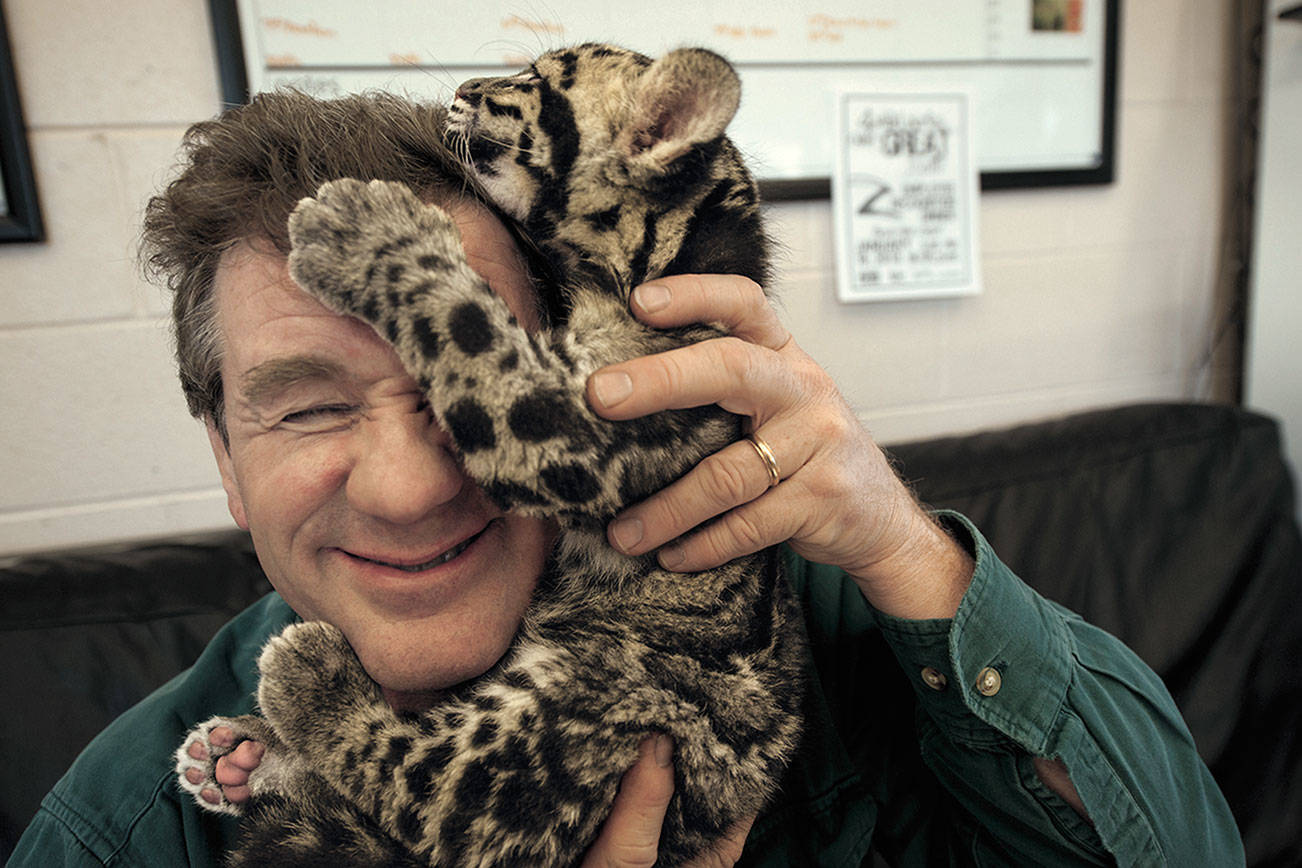 National Geographic Photo Ark (natgeophotoark.org) founder Joel Sartore, seen here with a clouded leopard cub at Ohio's Columbus Zoo, is the speaker Monday night in Centrum's online Communiversity program.  Copyright Joel Sartore/National Geographic Photo Ark