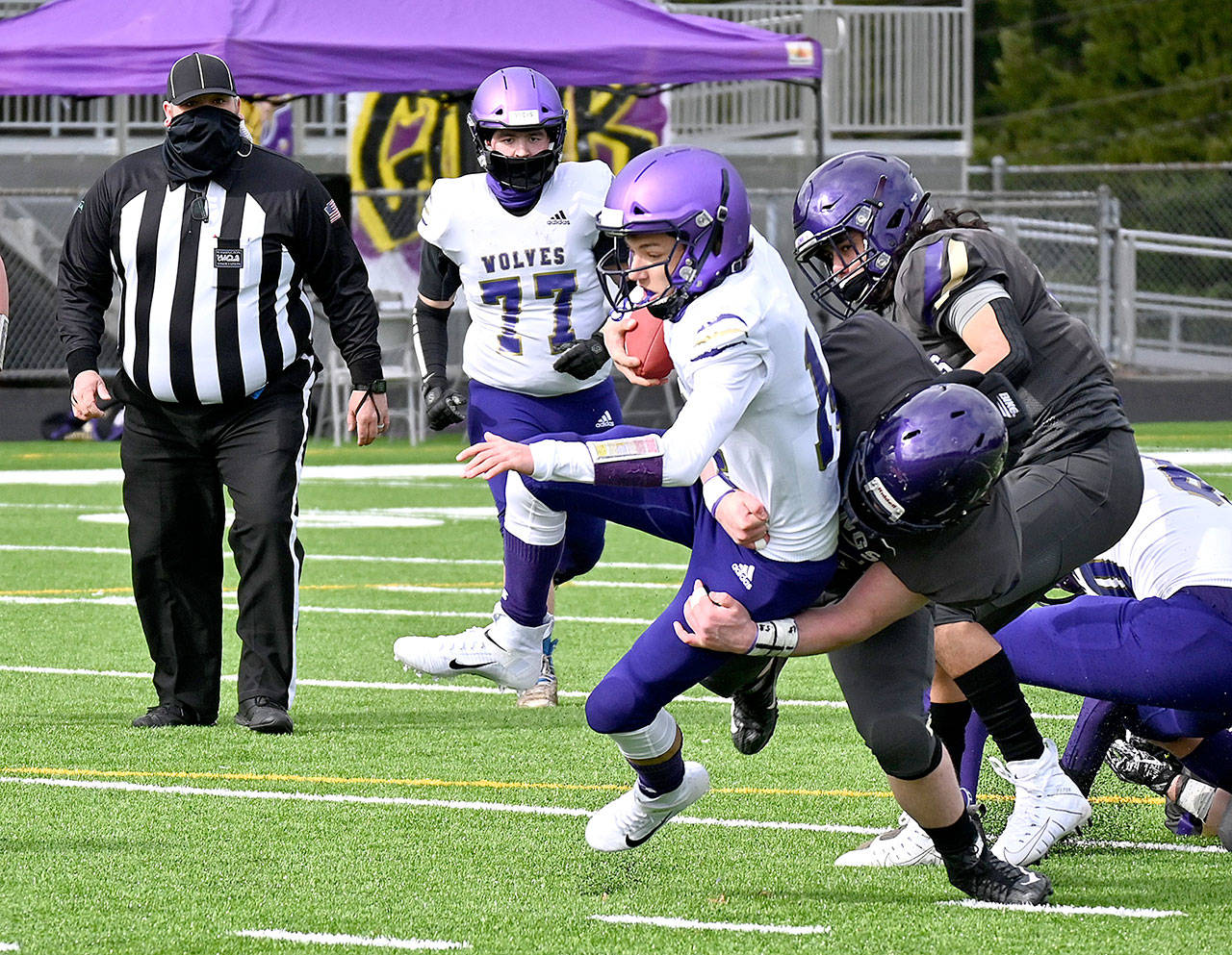 North Kitsap defenders tackle Sequim quarterback Kobe Applegate in the first half of the Vikings’ 28-0 rout of their Olympic League rivals in Poulsbo on Saturday afternoon. (Michael Dashiell/Olympic Peninsula News Group)