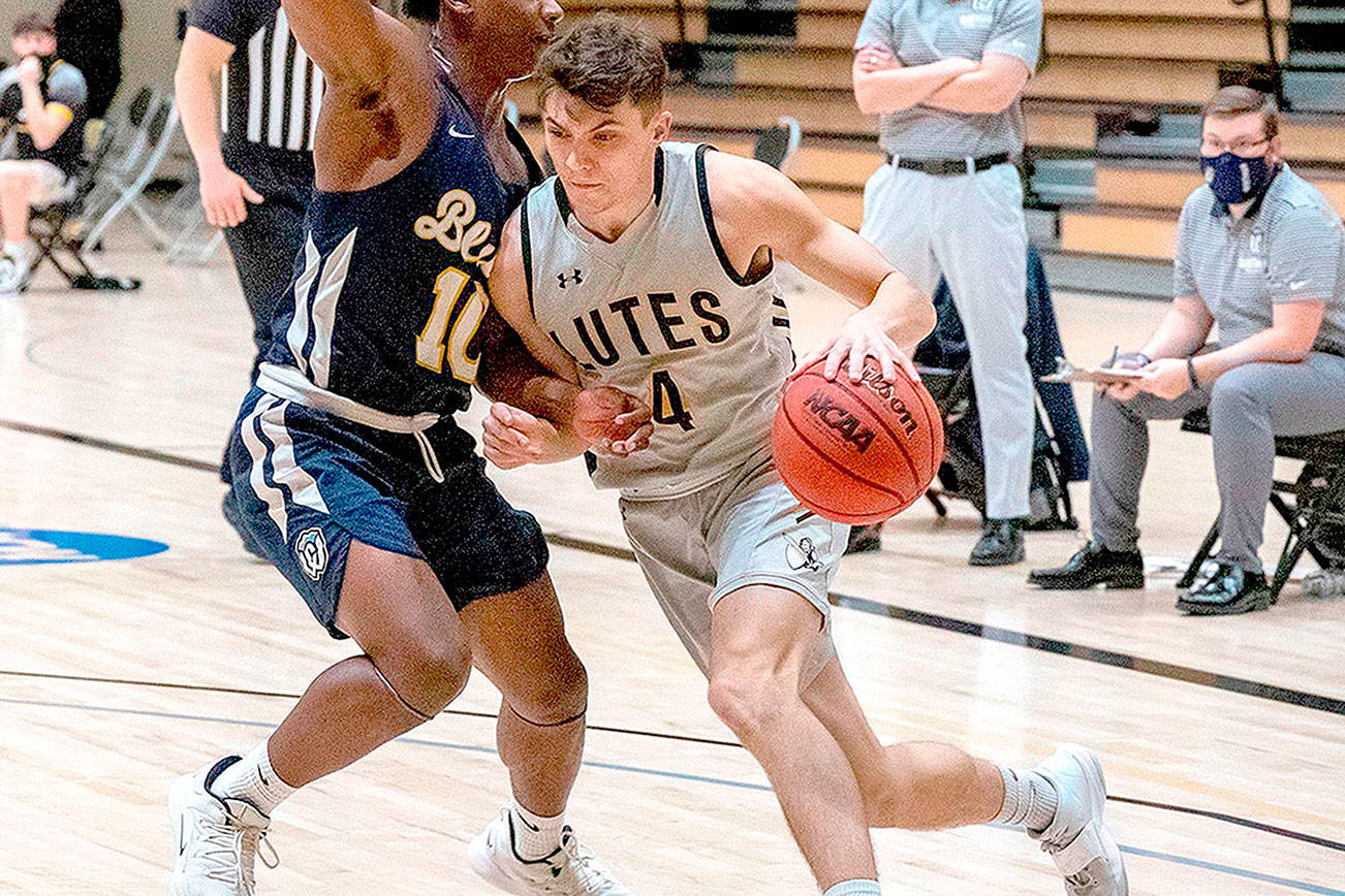 Ally Downey/Pacific Lutheran University Athletics
Pacific Lutheran guard Grayson Peet drives during a game earlier this season. The 2017 Port Angeles grad sank two 3-point baskets in a win over rival Puget Sound on Saturday.