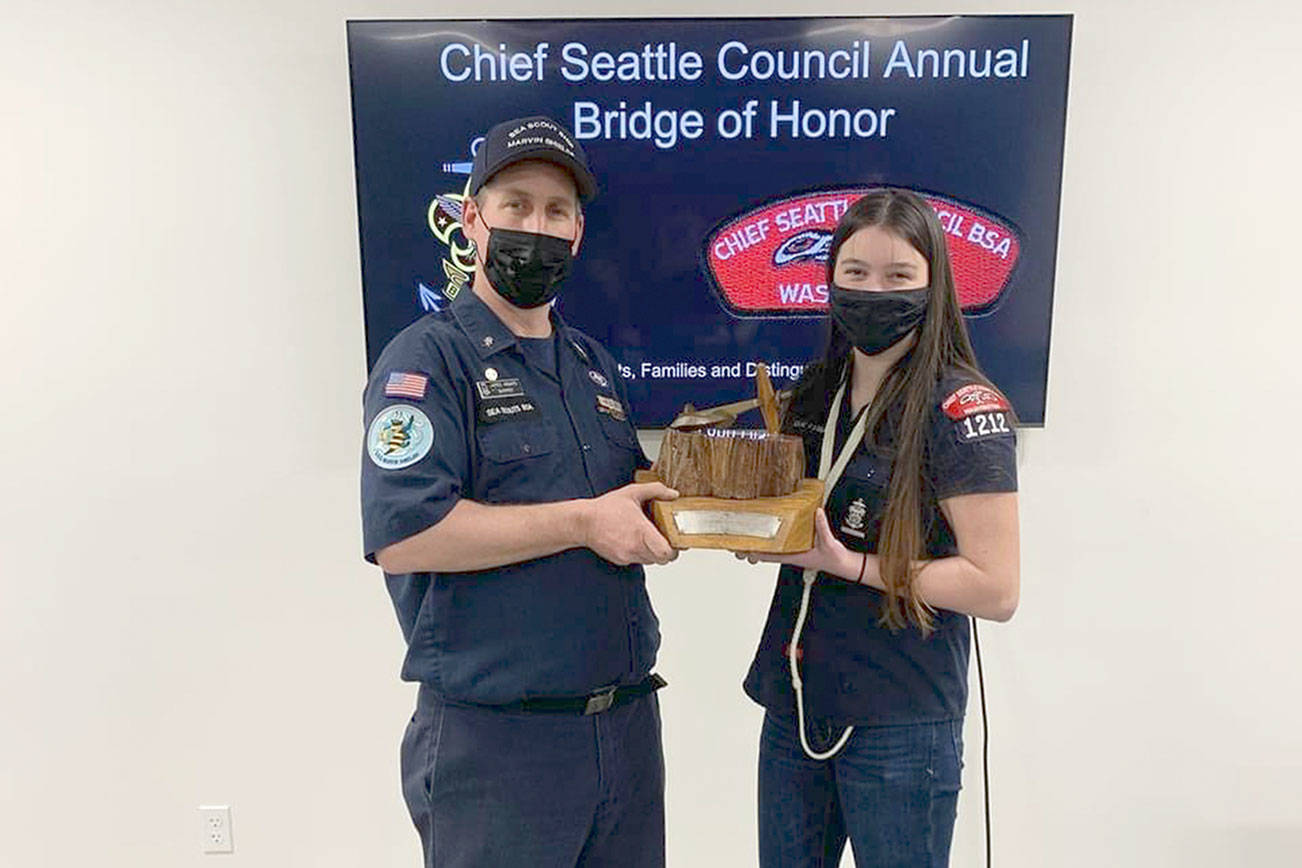 Skipper Jared Minard, left, and Ella Ventura, boatswain, accept the Hiltner Trophy for Sea Scout Ship Marvin Shields. The Chief Seattle Council named the Sea Scout Ship Marvin Shields, ship 1212, as its fleet flagship during a recent award ceremony. The selection as flagship allows the Marvin Shields to retain the traveling Hiltner Trophy and fly the flagship pennant at its masthead for the second year. The Sea Scouts is a program for youth ages 14-20. For more information, visit www.seascoutshipmarvinshields.org.