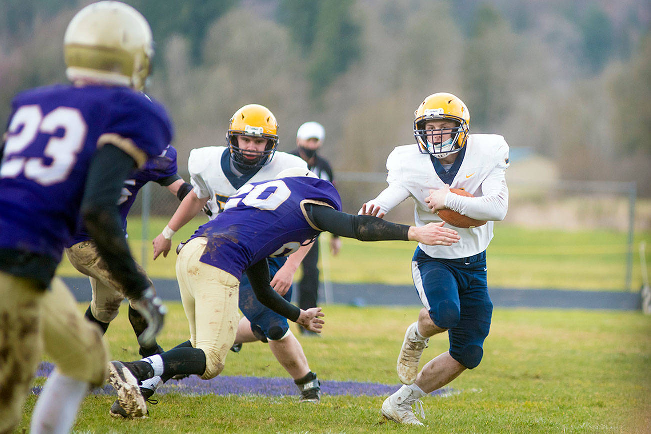 Eric Trent/The Chronicle
Forks' Colton Duncan runs with the football during a contest with defending state champion Onalaska earlier this season. Duncan, a senior, works for the city of Forks Public Works Department and is a volunteer firefighter.