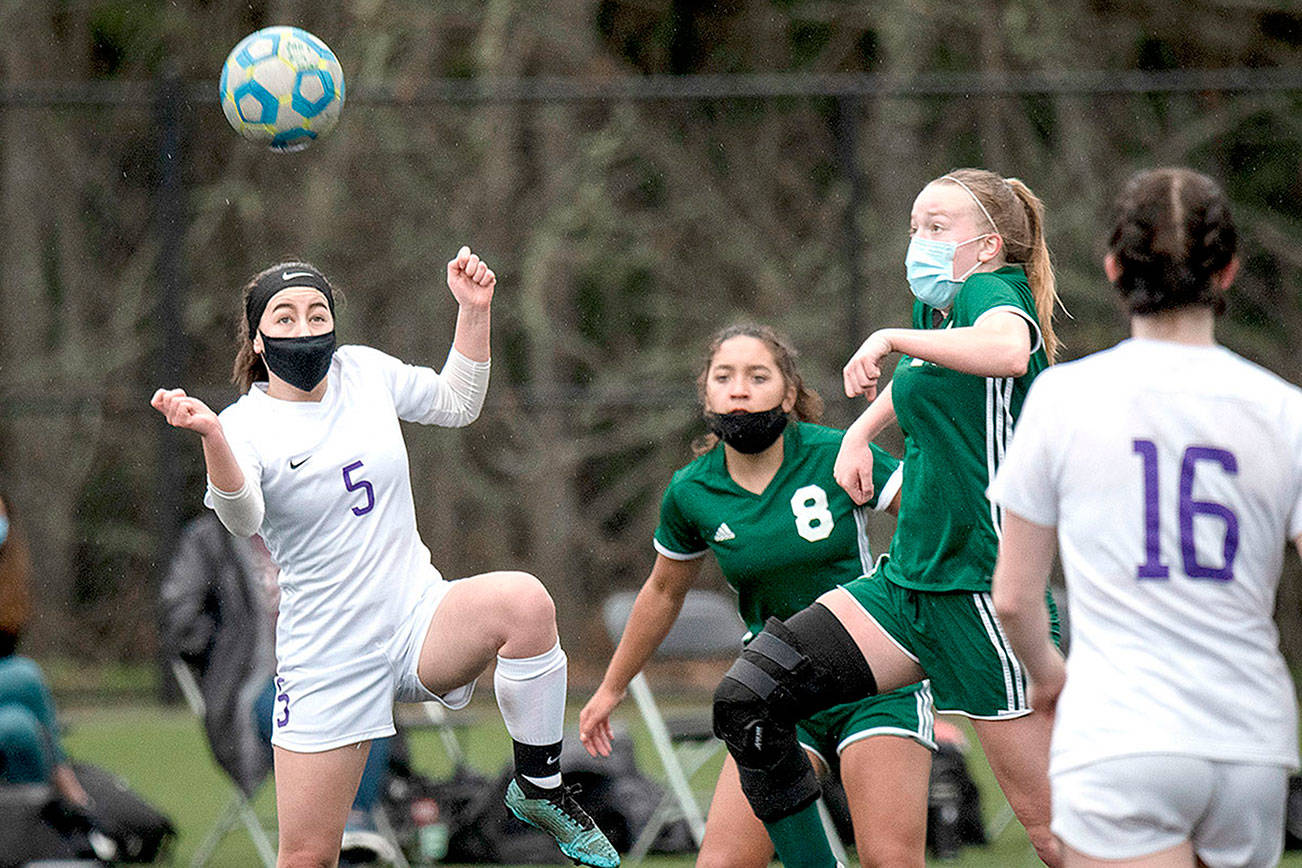 Jesse Major/for Peninsula Daily News
Sequim's Kariya Johnson (5) and Port Angeles' Anna Petty battle over a loose ball Saturday at Wally Sigmar Field at Peninsula College.