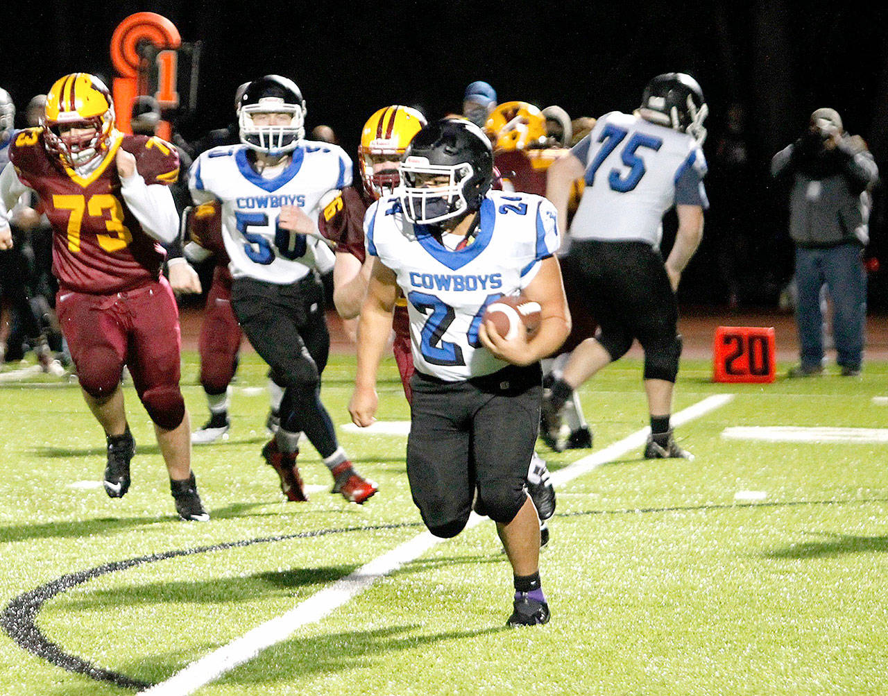 East Jefferson’s Anson Jones (24) looks for running room against the Kingston defense Friday night. Jones rushed for 92 yards as Kingston won 12-7. (Mark Krulish/Kitsap News Group)