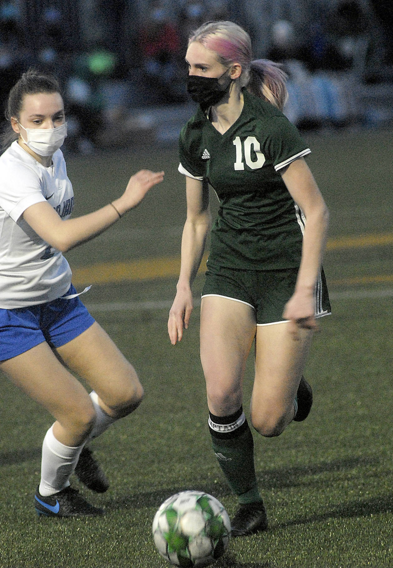 <strong>Keith Thorpe</strong>/Peninsula Daily News
Port Angeles’ Millie Long, right, looks past the defense of Olympic’s Claire Caldwell in the first half of Thursday night’s match at Peninsula College in Port Angeles.