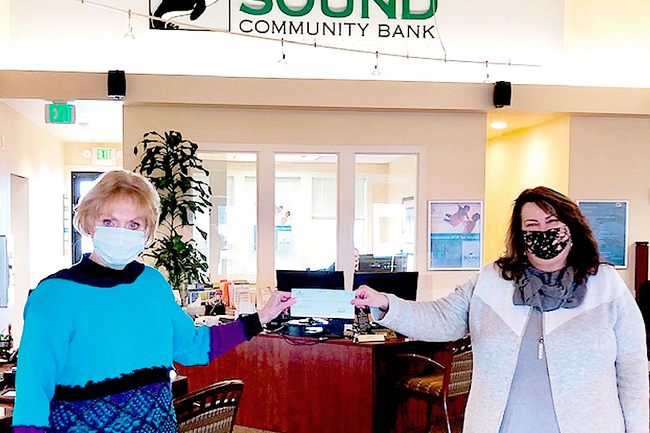 Danette Grady, on left, receives a $350 donation from Shelli Robb Kahler, vice-president of Sound Community Bank’s Sequim Village and Sequim Creekside branch offices, to assist with the care of rescued animals at the Peninsula Friends of Animals’ cageless, no-kill shelter. 

Grady is the executive director of the animal welfare organization.