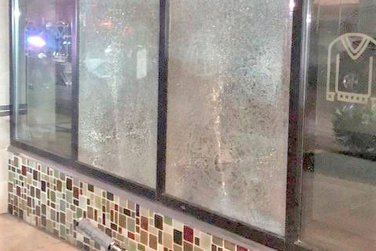 FILE- This March 12, 2021, file photo released by Portland Police Bureau shows smashed windows left behind by people inside the perimeter of a march by a group of about 100 hundred protesters Friday night in Portland, Ore. Portland Mayor Wheeler on Monday, Mach 15, 2021 called for an end to violence and property destruction after businesses were damaged over the weekend. Oregon's largest city has seen a series of often violent protests following the police killing of George Floyd in Minneapolis. (Portland Police Department via AP, File)