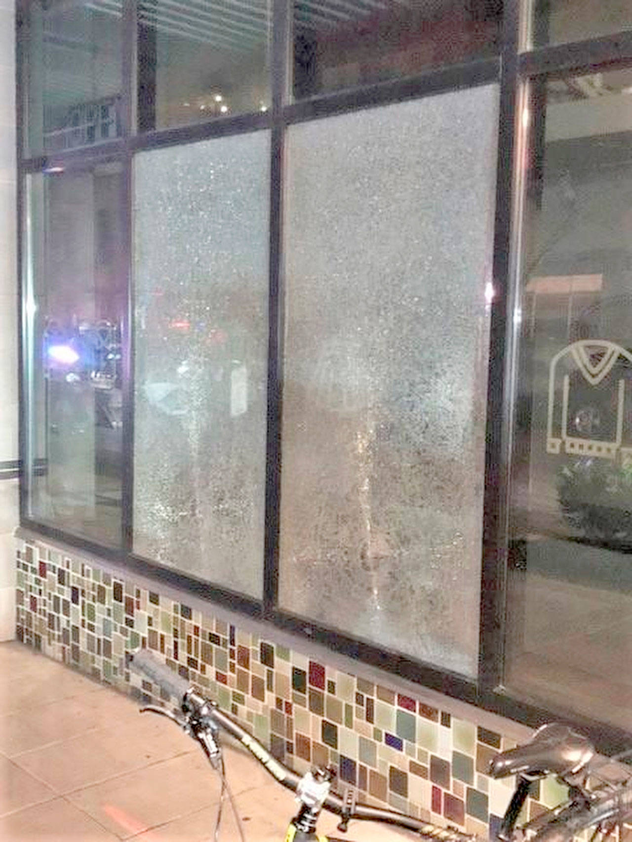 This March 12 photo released by Portland Police Bureau shows smashed windows left behind by people inside the perimeter of a march by a group of about 100 hundred protesters Friday night in Portland, Ore. Portland Mayor Wheeler on Monday called for an end to violence and property destruction after businesses were damaged last weekend. Oregon’s largest city has seen a series of often-violent protests following the police killing of George Floyd in Minneapolis. (Portland Police Department via The Associated Press)