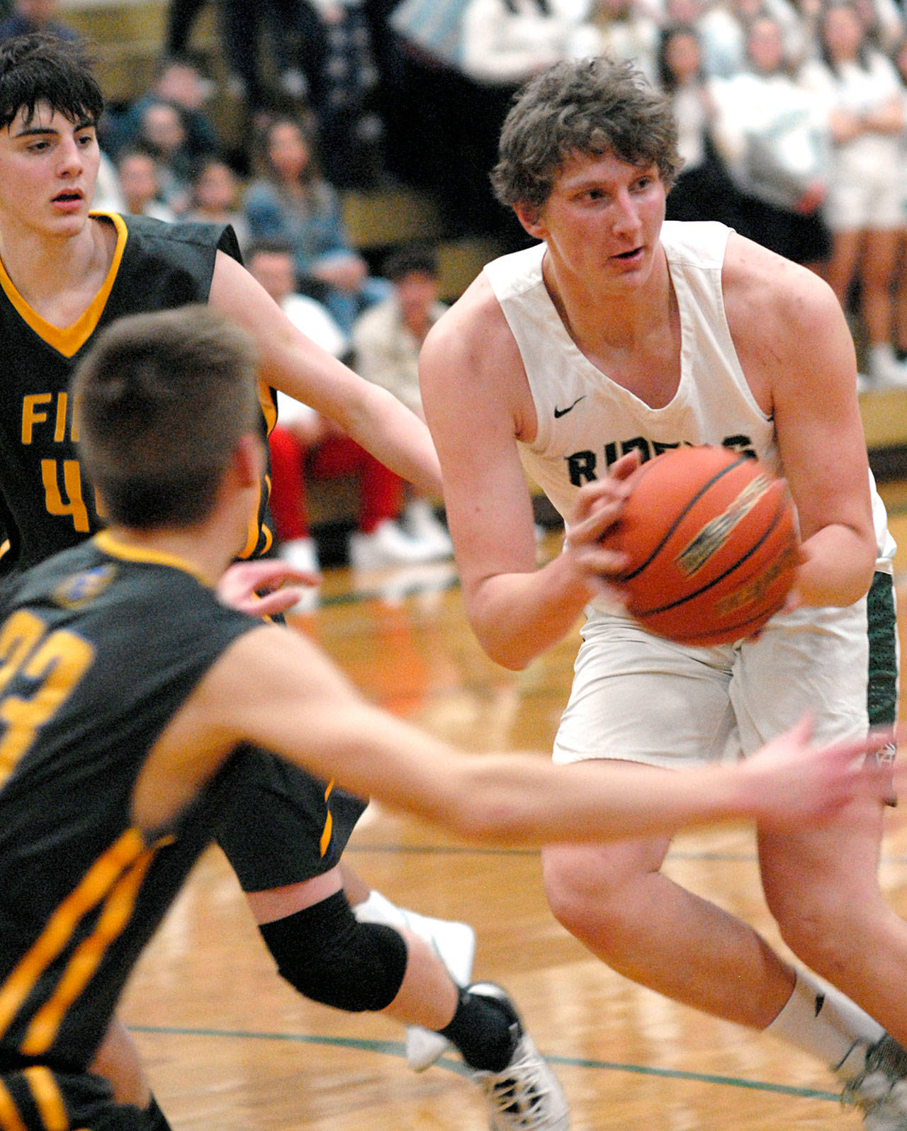 Port Angeles’ John Vaara, right, plays for the Roughriders in December 2019. High-risk indoor sports such as basketball and wrestling can return in late April under the state’s new Phase 3 COVID-19 guidelines. Spring sports with increased fans begin next week. (Keith Thorpe/Peninsula Daily News)