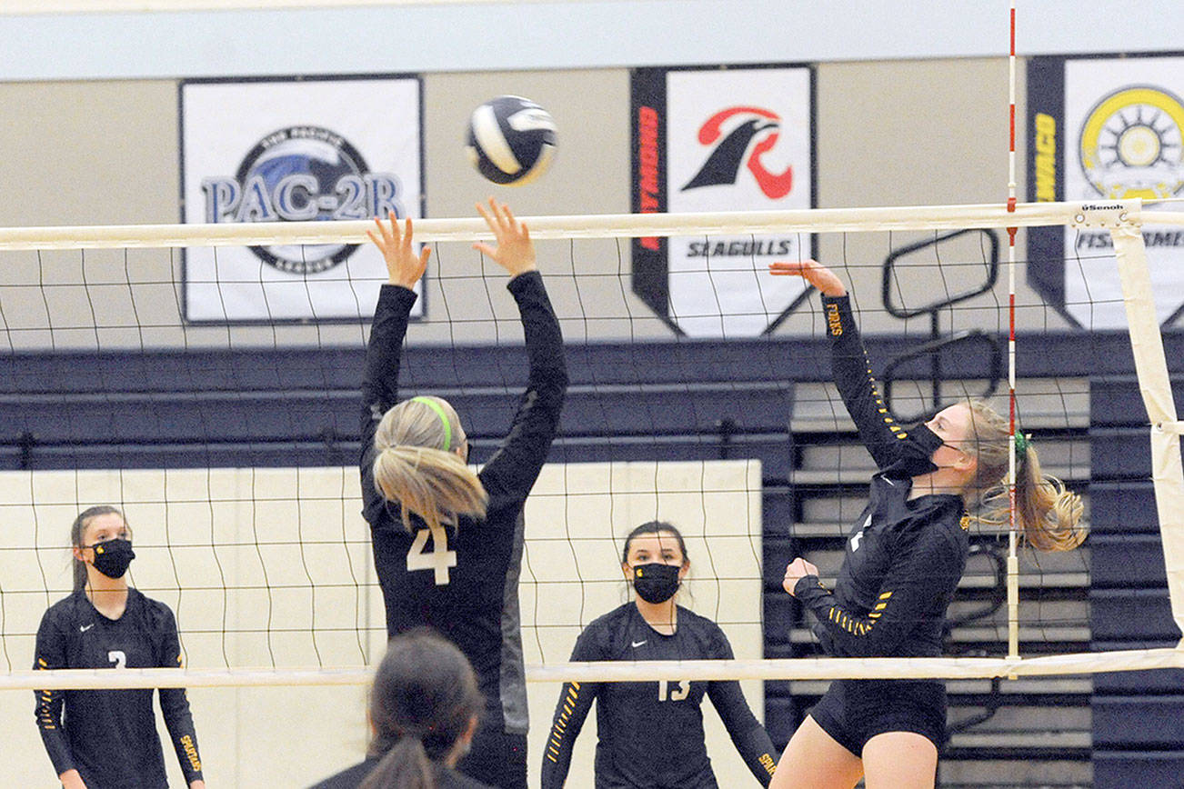 Napavine's Grace Gall (4) attempts to block a hit by Forks' Katie Wood on Wednesday evening in Forks, where the Tigers defeated the Spartans 3-0 in the Class 2B Southwest District Volleyball Tournament. (Lonnie Archibald/for Peninsula Daily News)