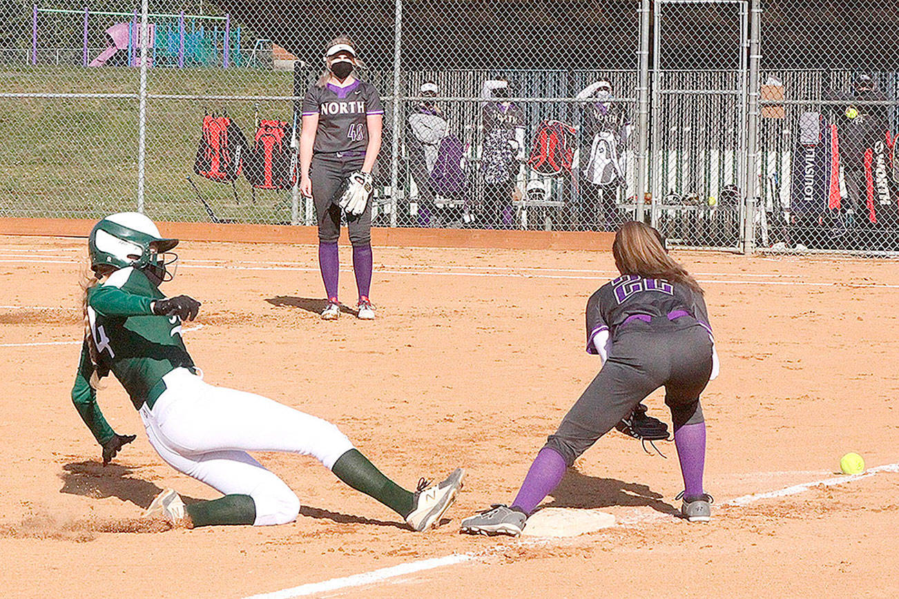 Dave Logan/for Peninsula Daily News
Port Angeles' Teagan Clark slides safely into third base while North Kitsap's Allison Dvorak fields the throw from the catcher during the Roughriders' 5-4 walk-off win Monday at Dry Creek Elementary School.