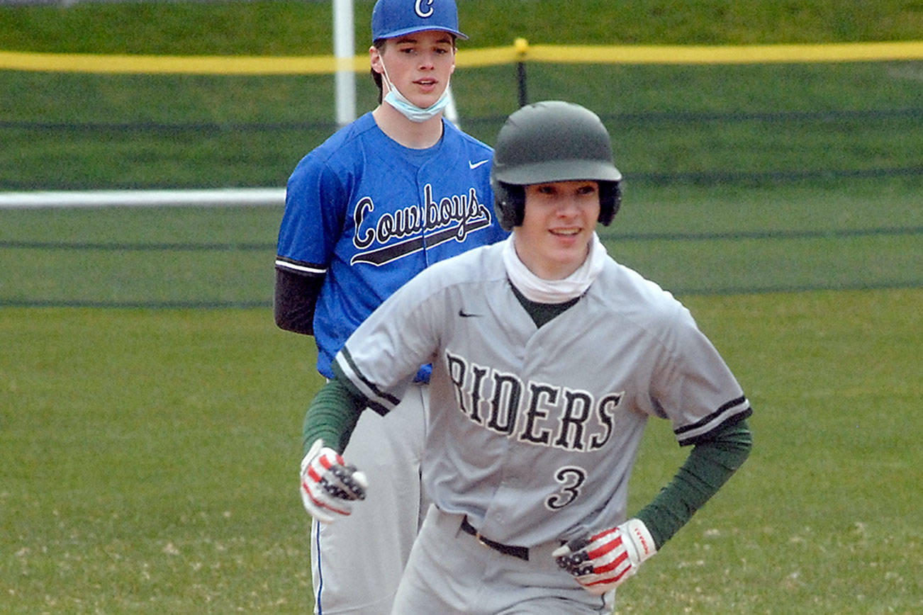 Port Angeles' Landon Seibel rounds second past East Jefferson's Ryan Popp after Seibel hamnered a bases loaded homer in the third inning on Tuesday at Port Angeles Civic Field.