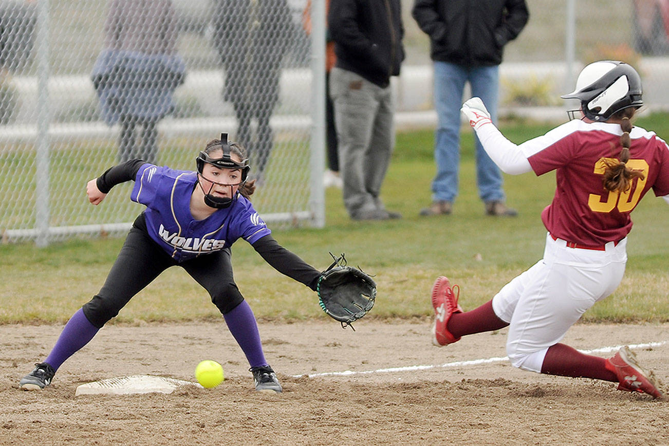 Sequim shortstop Hannah Bates looks to put a tag on a Kingston baserunner in the Wolves’ 19-3 win over the visiting Buccaneers on Wednesday. (Michael Dashiell/Olympic Peninsula News Group)