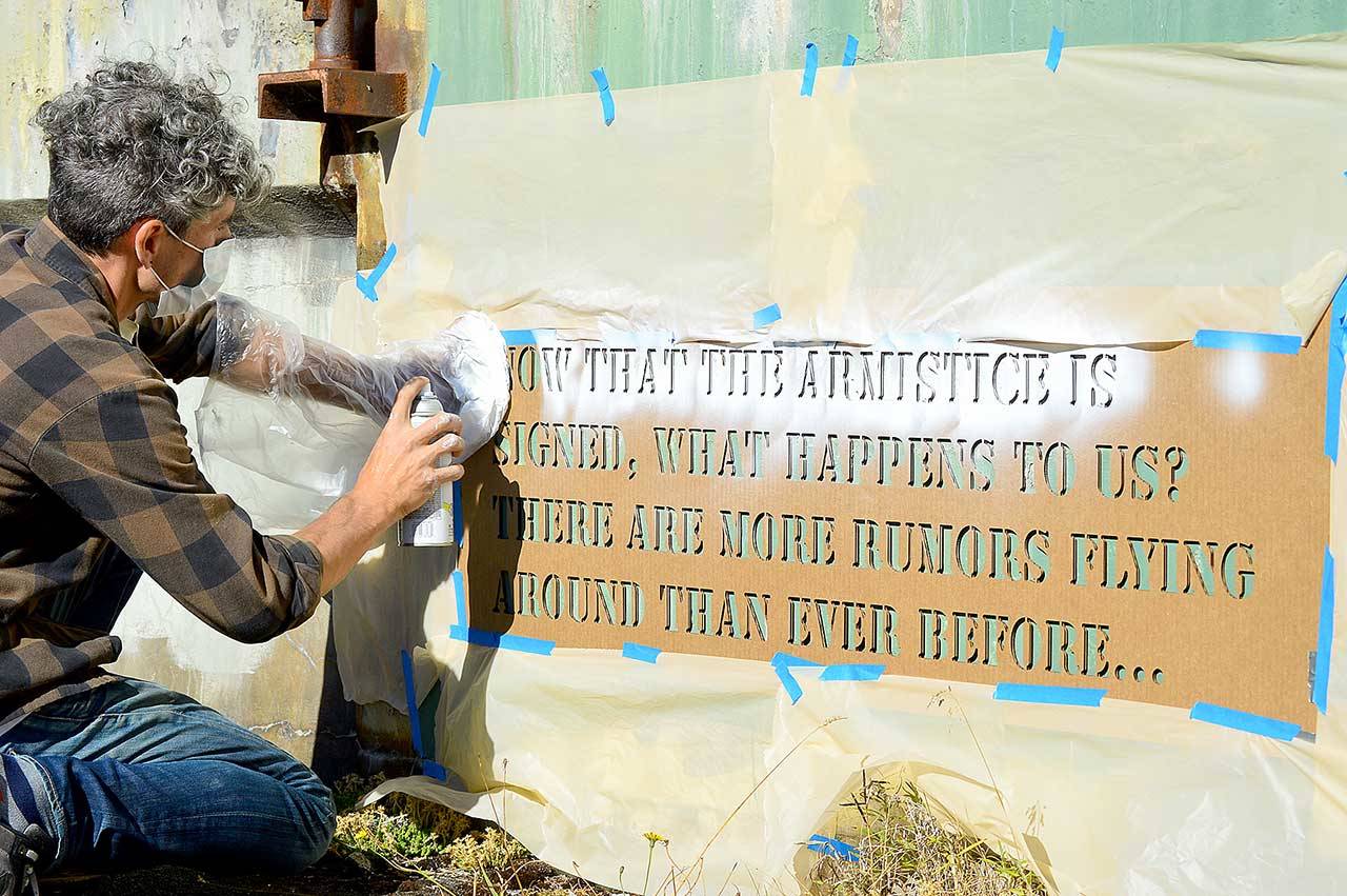 Aaron Asis, installing his “Fort Words” paintings at Fort Worden State Park last September, is among the many artists who have received Port Townsend Arts Commission grants. (Diane Urbani de la Paz/Peninsula Daily News)