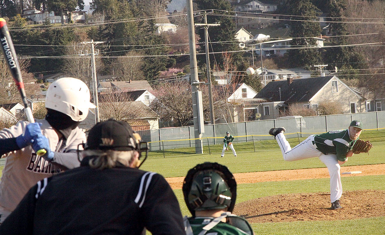 Port Angeles pitcher Adam Watkins throws a strike to a Bainbridge batter in the third inning Monday. (Dave Logan/for Peninsula Daily News)